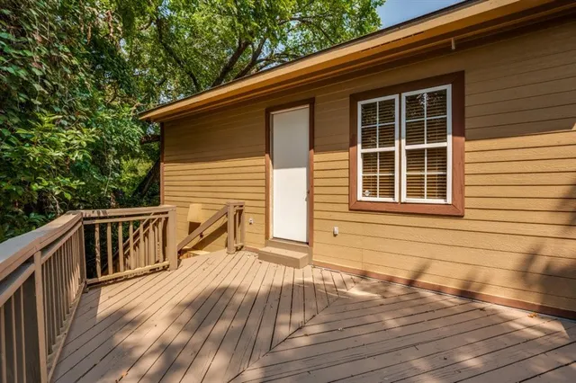 a view of balcony with wooden floor and fence