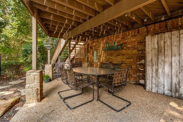 a view of house with deck and wooden floor