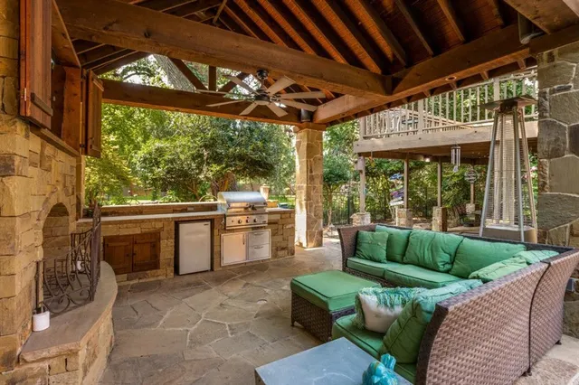 a view of a porch with furniture and a fireplace