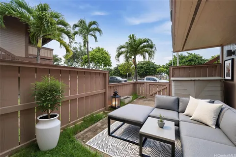 a view of a backyard with a tub and potted plants