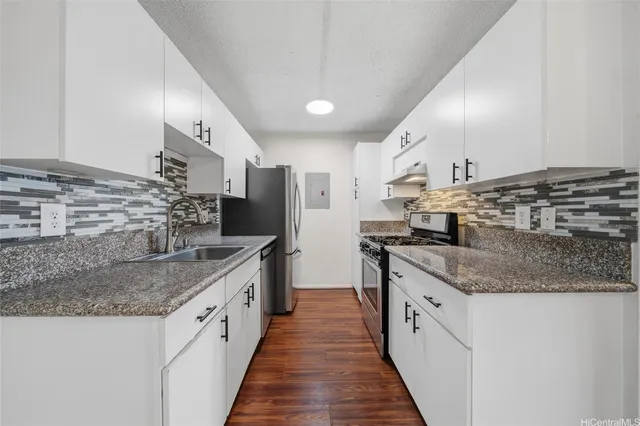 a kitchen with stainless steel appliances granite countertop a sink and stove