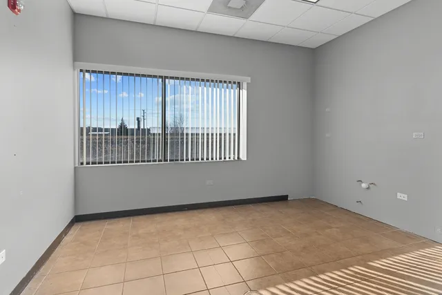 a view of a livingroom with workspace and a window