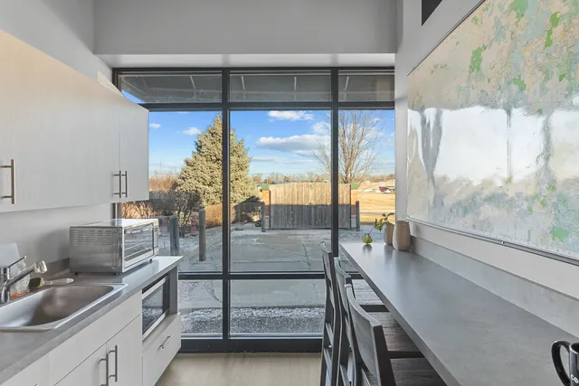 a view of a dining room with furniture and floor to ceiling window