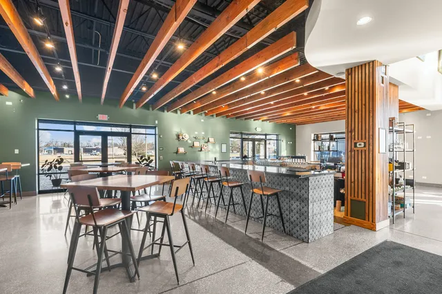 a large kitchen with stainless steel appliances granite countertop a large stove a sink and a wooden floors