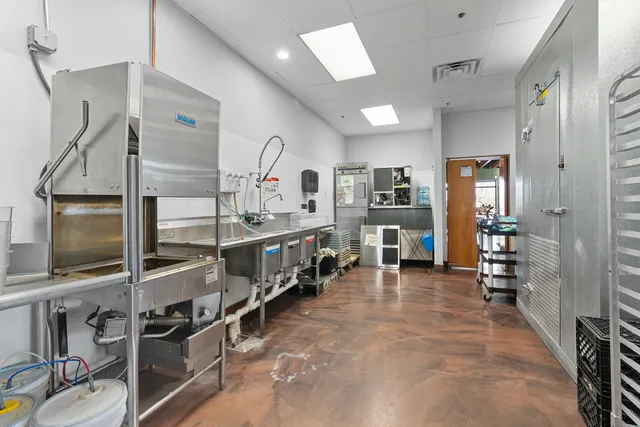 a view of a patio with a dining table and chairs under an umbrella