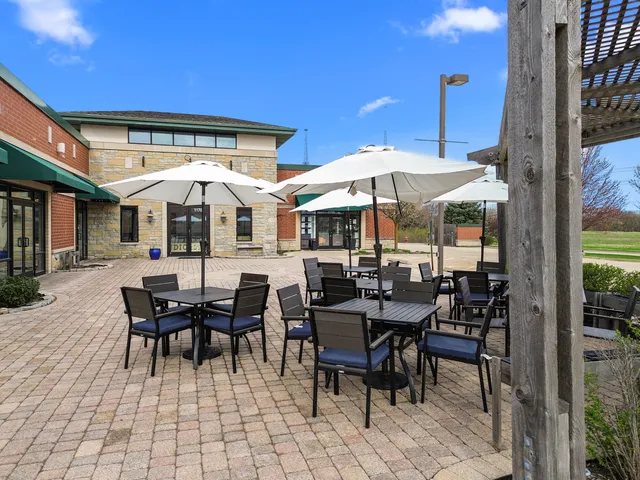 a view of a patio with a dining table and chairs