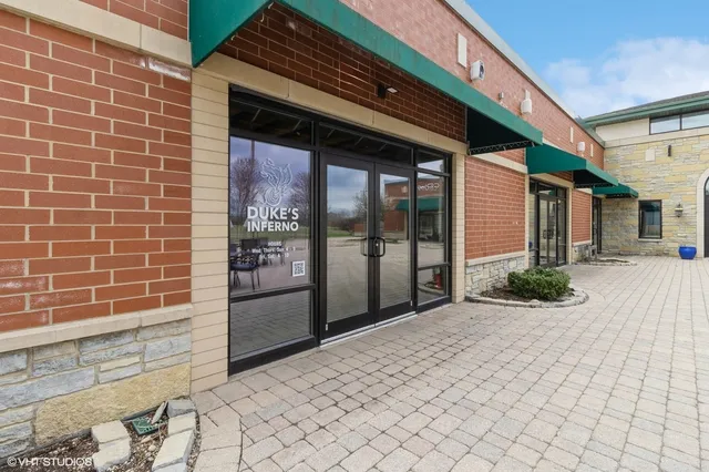 a view of a brick house with a potted plant