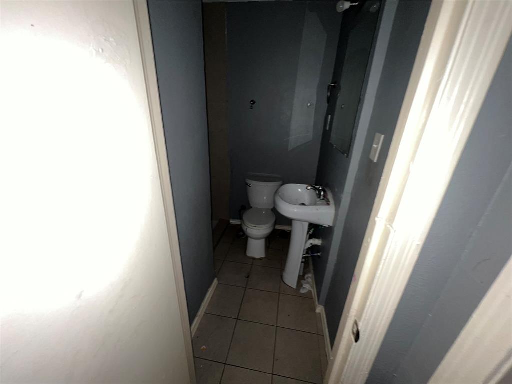 4224 Ramey Avenue Fort Worth, TX 76105 - Photo 9 of 19 Half bathroom featuring light tile patterned flooring and toilet