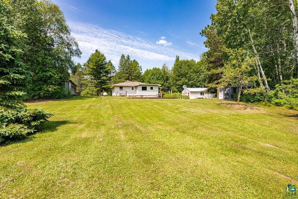 2592 Strandberg Road Barnum, MN 55707 - Photo 8 of 44 Expansive grassy lawn with surrounding mature trees and a single-story residence
