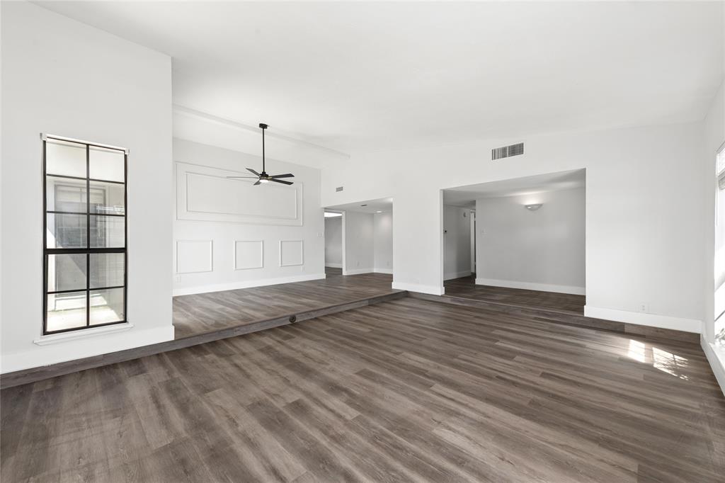 2119 Meadfoot Road Carrollton, TX 75007 - Photo 4 of 30 Unfurnished living room featuring dark wood finished floors and a ceiling fan