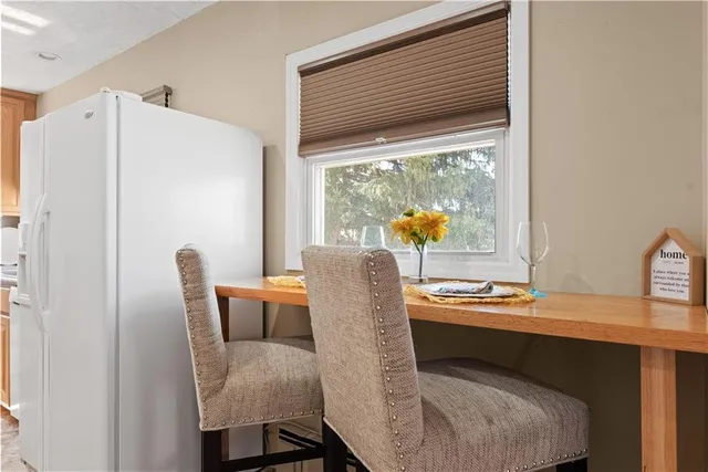 a dining room with furniture and a window