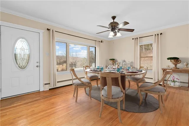 a view of a dining room with furniture window and wooden floor