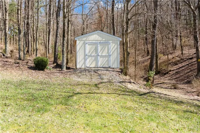 a view of a yard with large trees