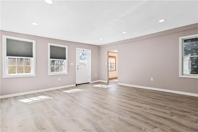 wooden floor in an empty room with a window
