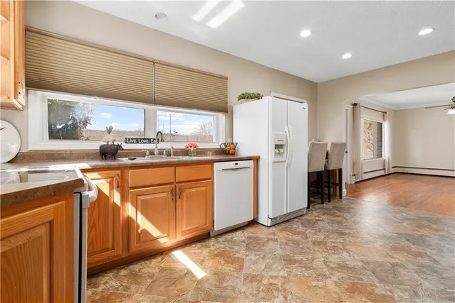 a kitchen with stainless steel appliances granite countertop a refrigerator and a stove top oven