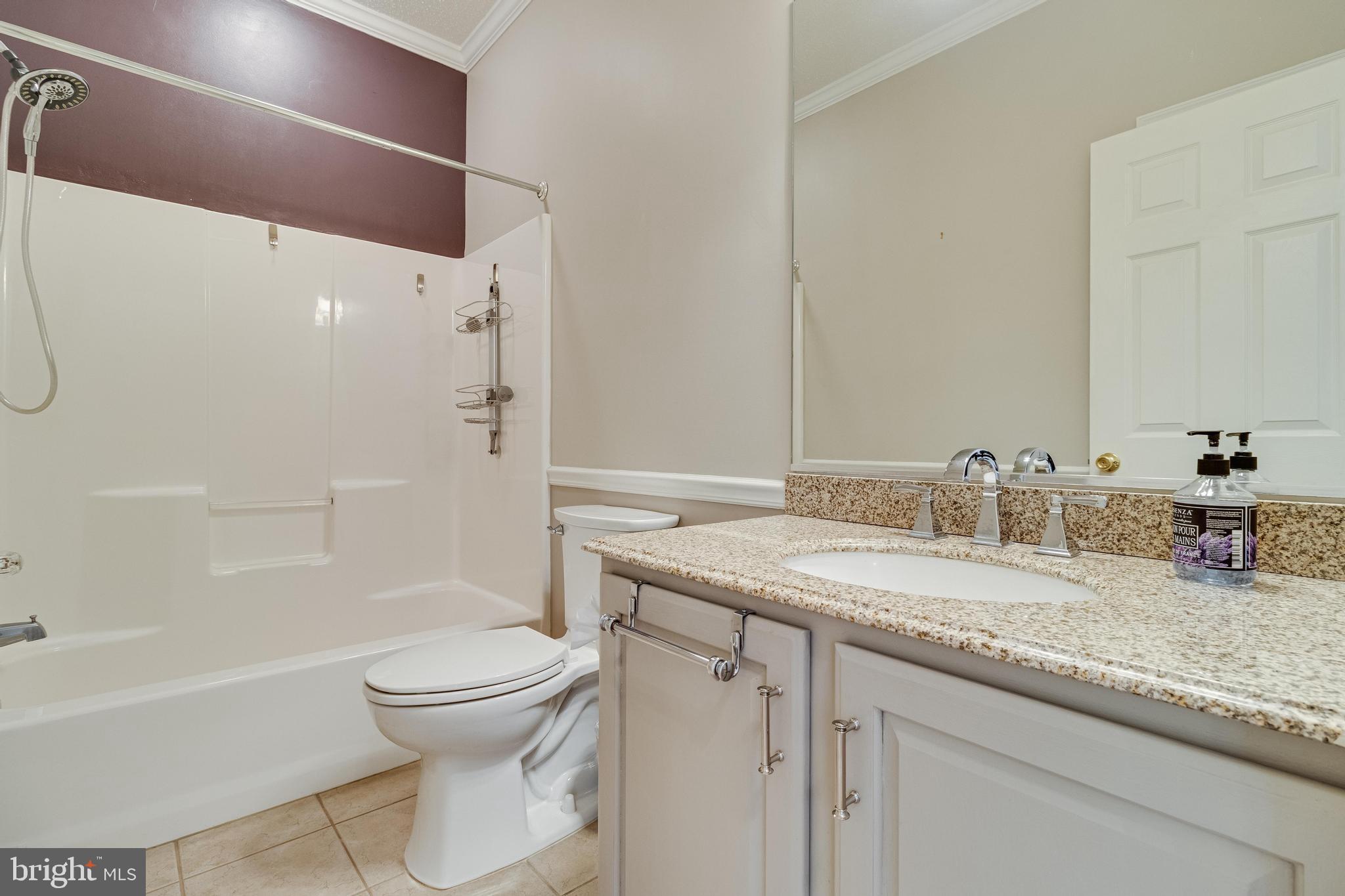 14850 King Charles Drive Issue, MD 20645 - Photo 19 of 63 a bathroom with a granite countertop sink toilet and shower