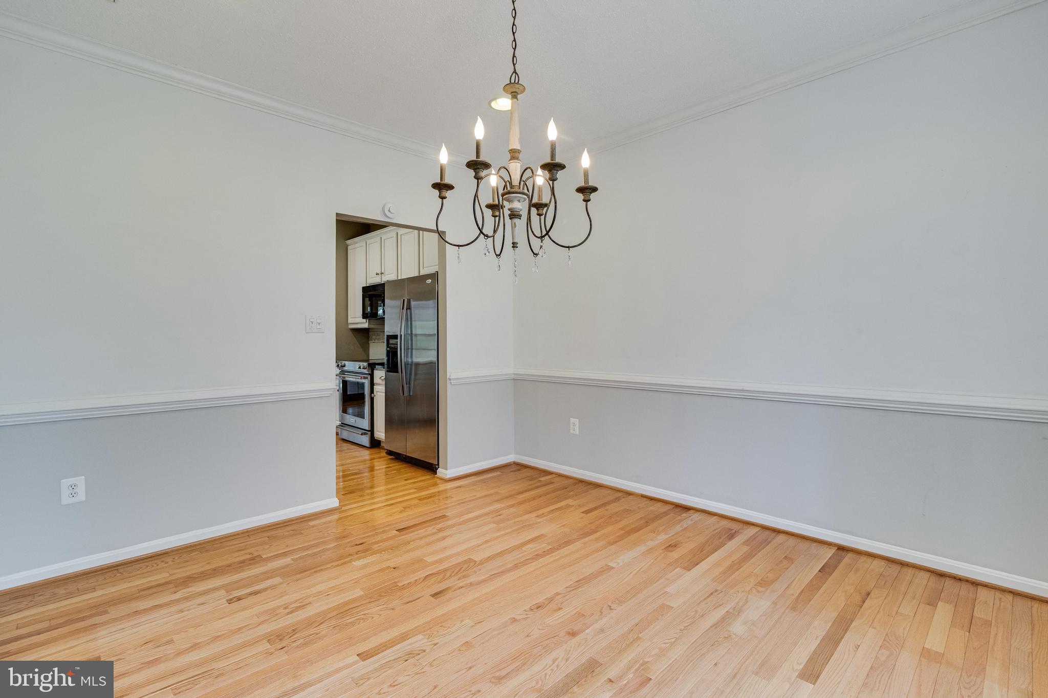 14850 King Charles Drive Issue, MD 20645 - Photo 21 of 63 a view of a room with wooden floor and chandelier
