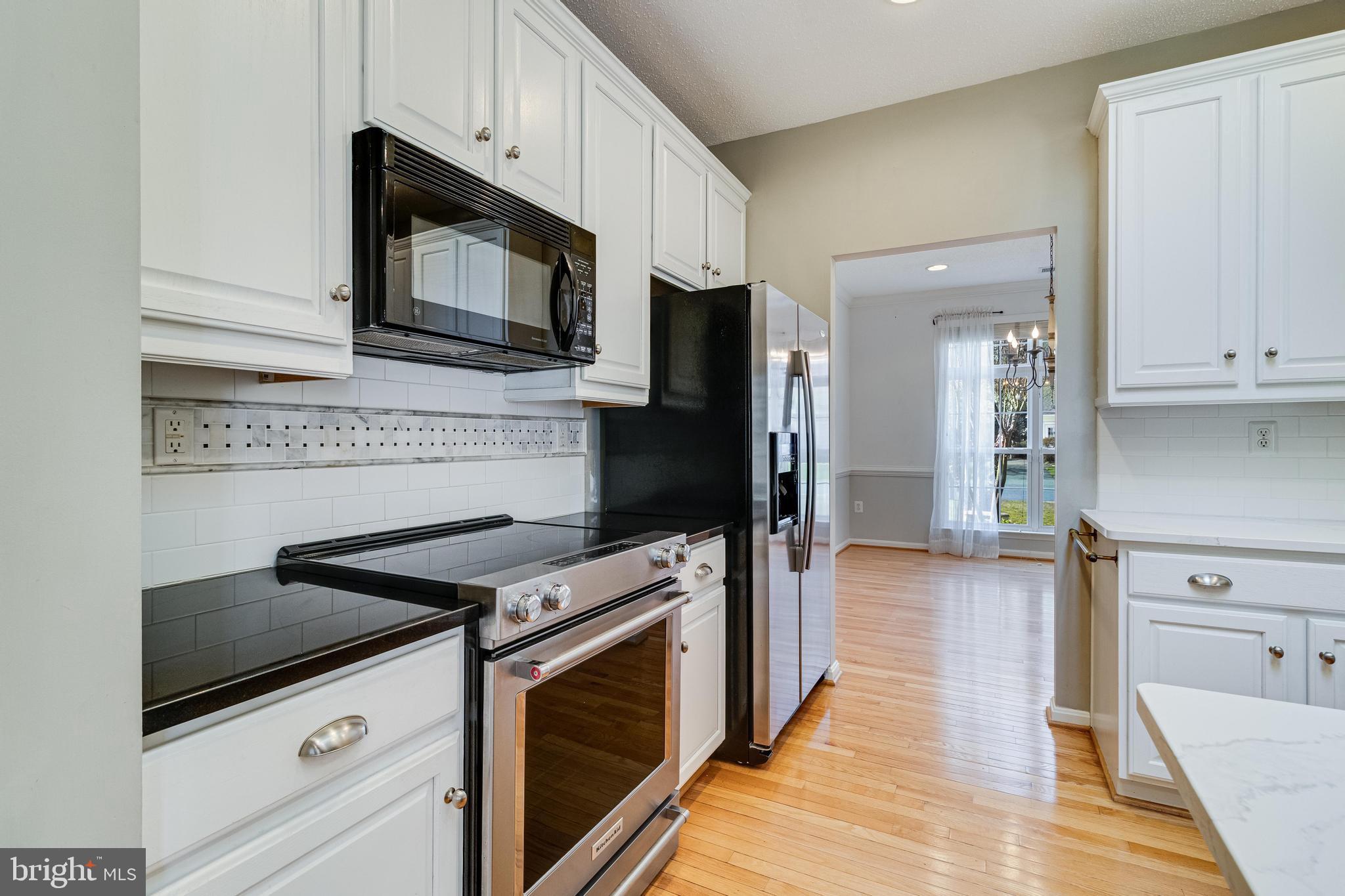 14850 King Charles Drive Issue, MD 20645 - Photo 23 of 63 a kitchen with a stove and a microwave