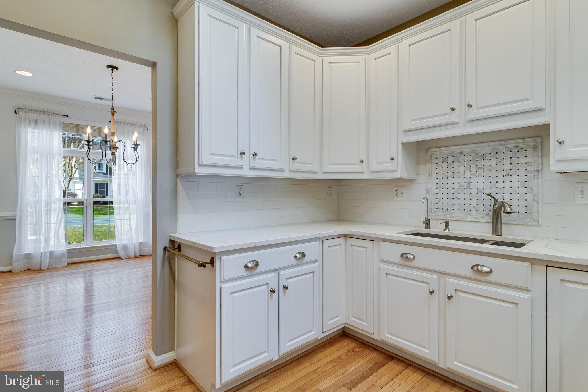 14850 King Charles Drive Issue, MD 20645 - Photo 24 of 63 a kitchen with stainless steel appliances granite countertop a sink a stove and cabinets