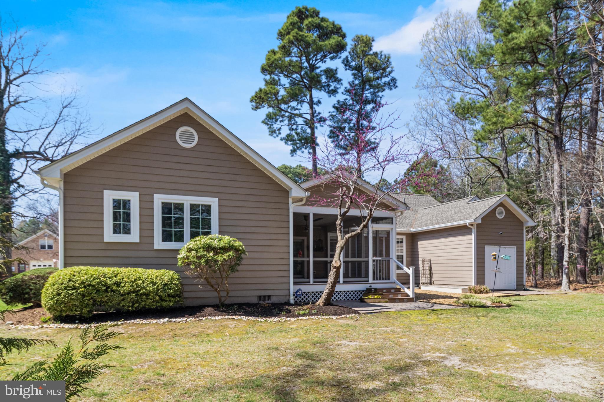 14850 King Charles Drive Issue, MD 20645 - Photo 40 of 63 a front view of a house with a yard and garage