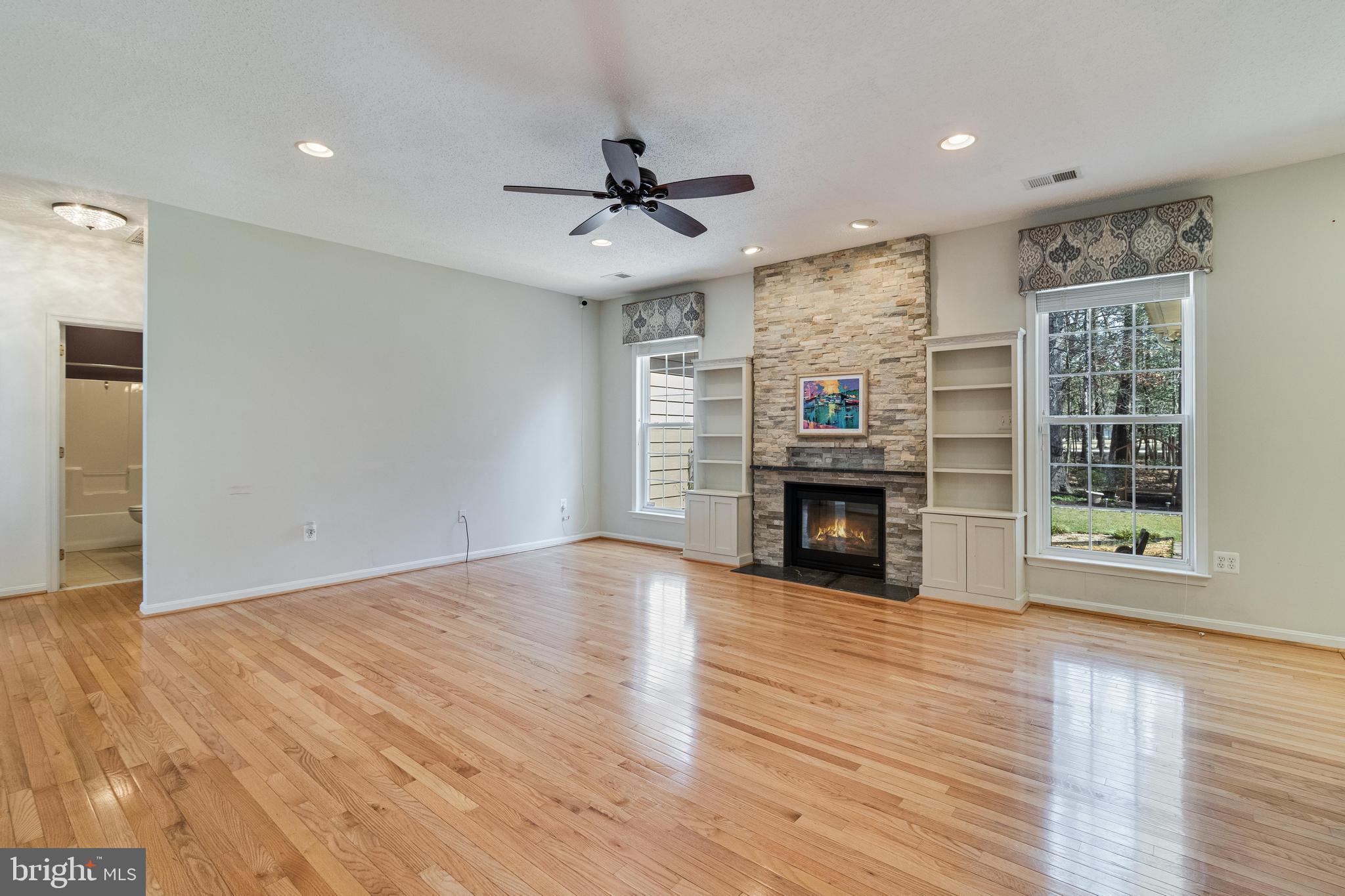 14850 King Charles Drive Issue, MD 20645 - Photo 5 of 63 a view of an empty room with wooden floor fireplace and a window