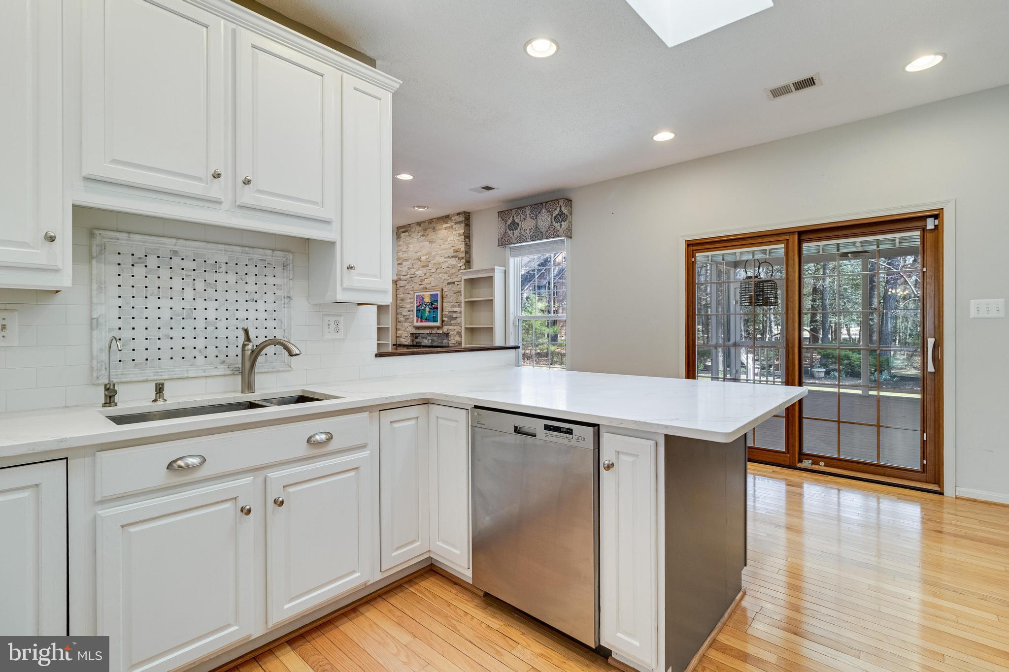 14850 King Charles Drive Issue, MD 20645 - Photo 7 of 63 a kitchen with counter top space sink and center island