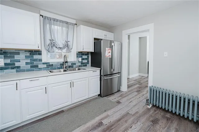 a kitchen with stainless steel appliances a refrigerator sink and cabinets