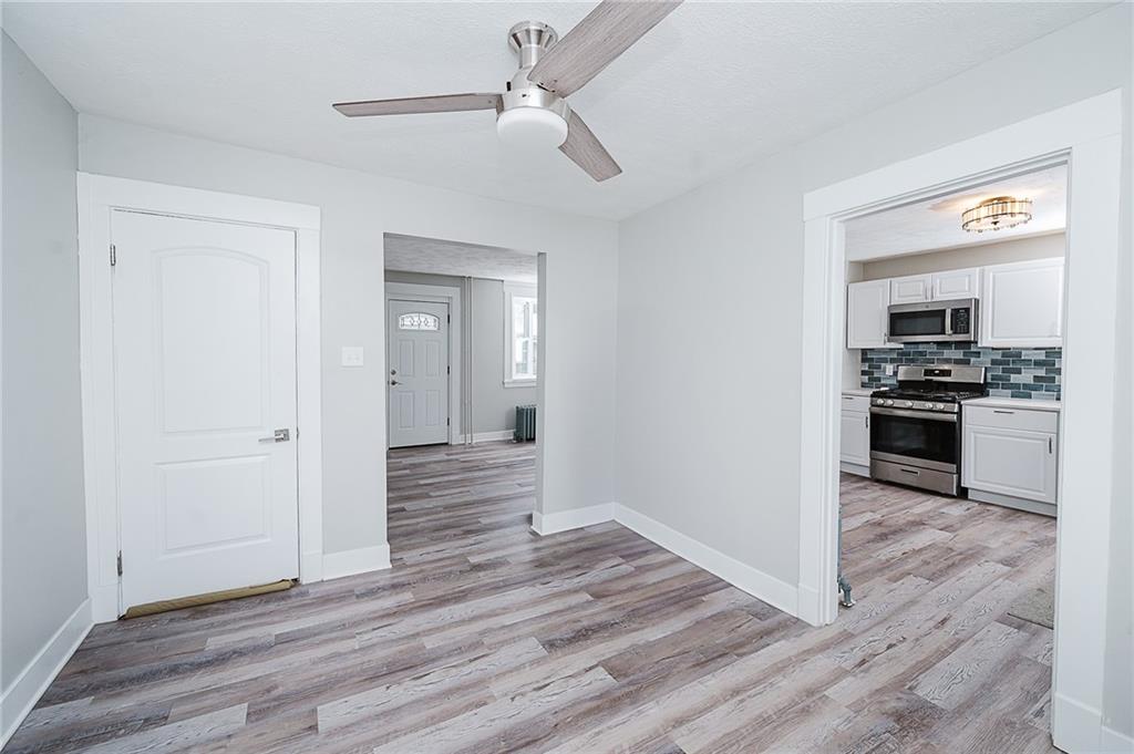 887 Millville Road Altoona, PA 16601 - Photo 15 of 29 a view of a kitchen with wooden floor electronic appliances and a ceiling fan