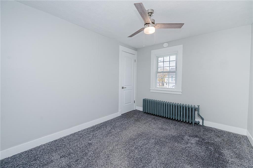 887 Millville Road Altoona, PA 16601 - Photo 18 of 29 an empty room with a window and a ceiling fan