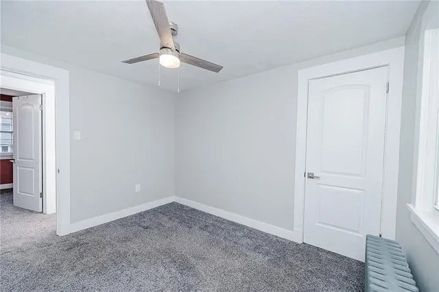 an empty room with a ceiling fan
