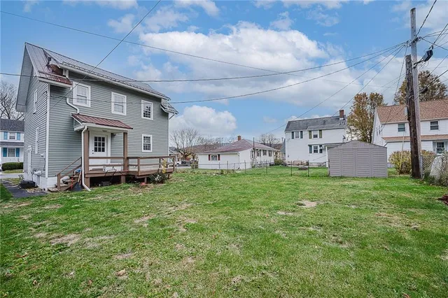 a backyard of a house with table and chairs
