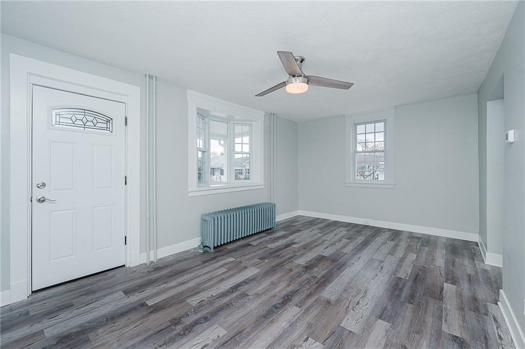 887 Millville Road Altoona, PA 16601 - Photo 6 of 29 a view of an empty room with wooden floor and a window