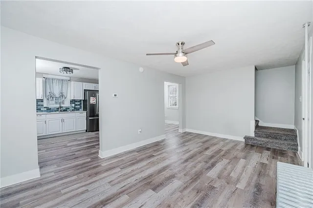 a view of a kitchen with wooden floor and a sink