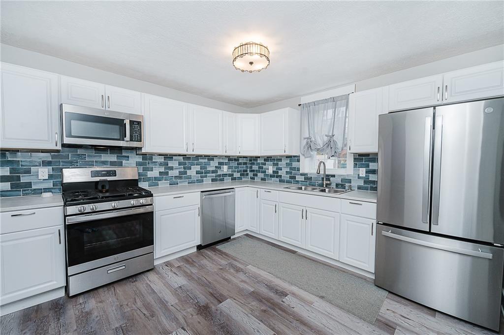 887 Millville Road Altoona, PA 16601 - Photo 9 of 29 a kitchen with a refrigerator stove and microwave