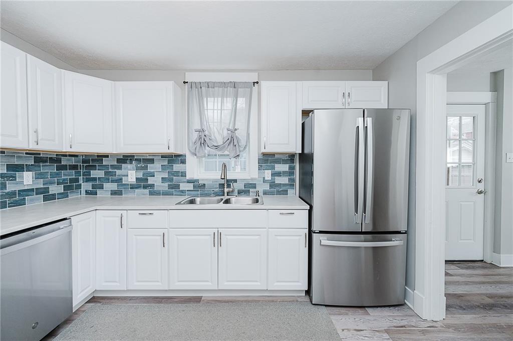 887 Millville Road Altoona, PA 16601 - Photo 10 of 29 a kitchen with white cabinets and stainless steel appliances