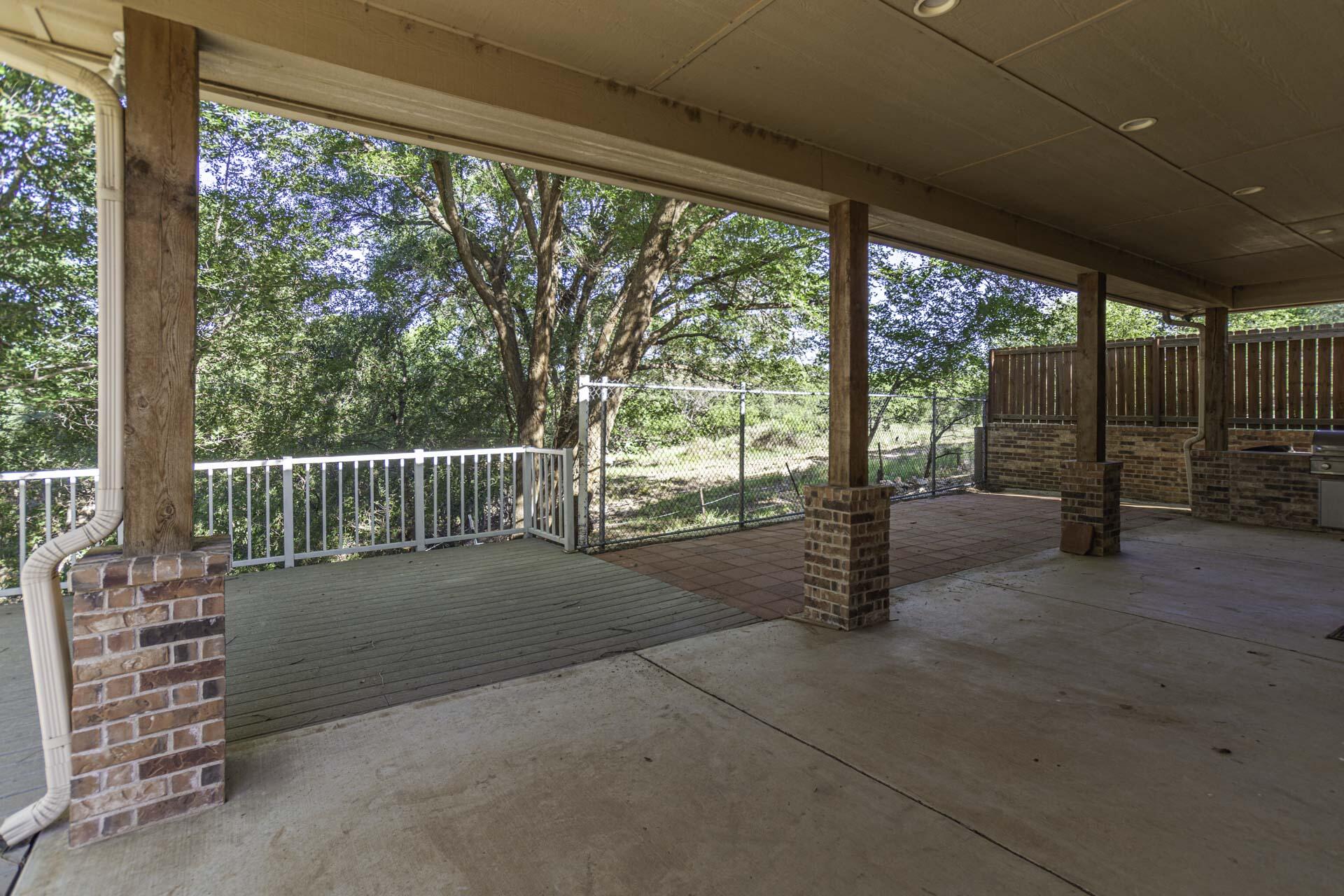 33 West Lakeshore Drive Ransom Canyon, TX 79366 - Photo 5 of 48 a view of a deck with chairs and floor to ceiling window