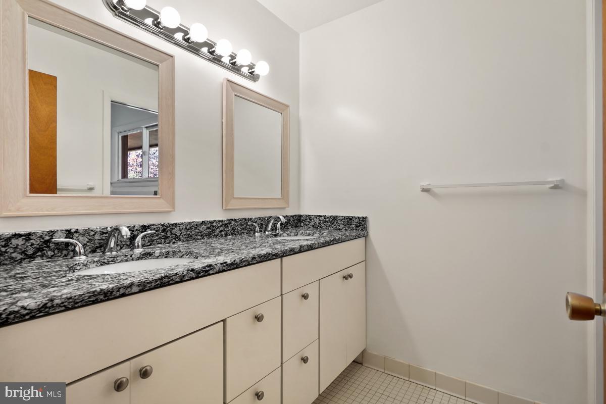 2606 Deerdell Lane Reston, VA 20191 - Photo 33 of 49 a bathroom with a granite countertop sink and a mirror