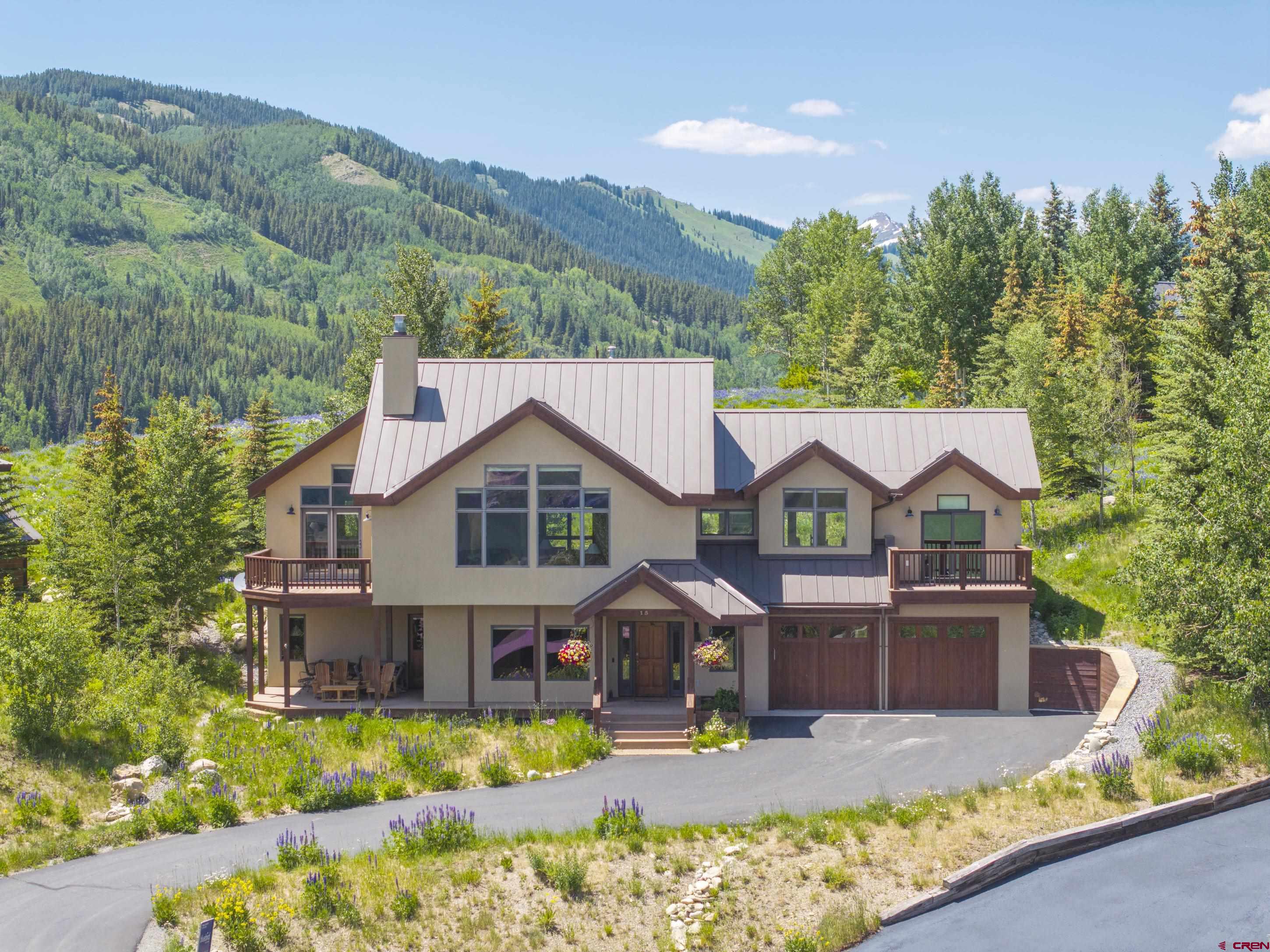 15 Nicholson Lane Crested Butte, CO 81224 - Photo 1 of 42 a front view of house with yard outdoor seating and green space