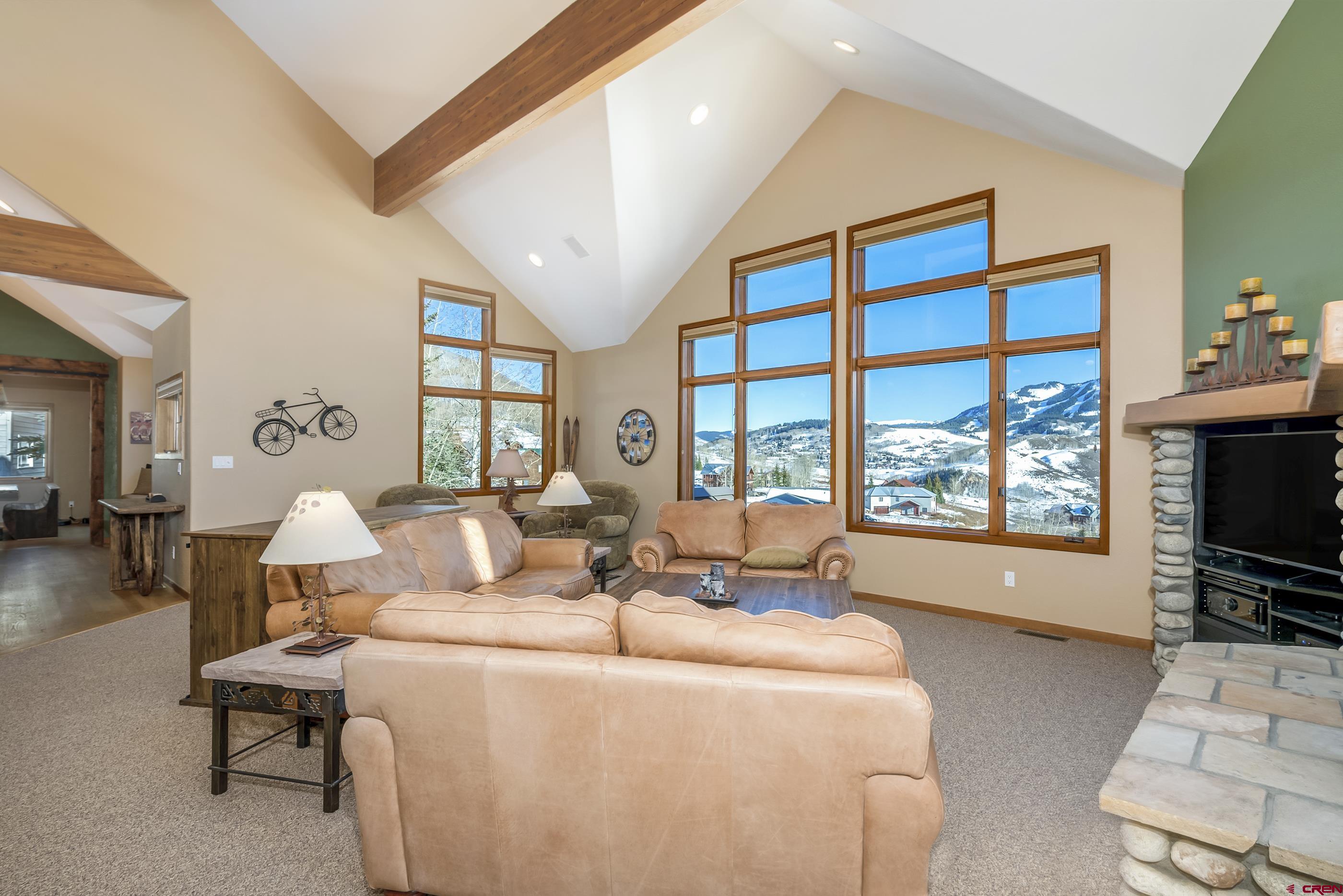 15 Nicholson Lane Crested Butte, CO 81224 - Photo 11 of 42 a living room with furniture a flat screen tv and a large window