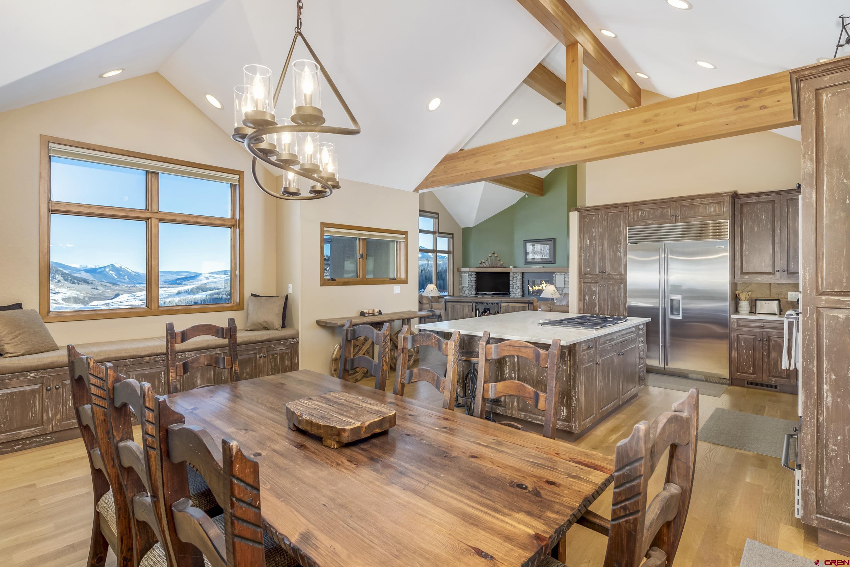 15 Nicholson Lane Crested Butte, CO 81224 - Photo 16 of 42 a view of a dining room with furniture a chandelier and large windows