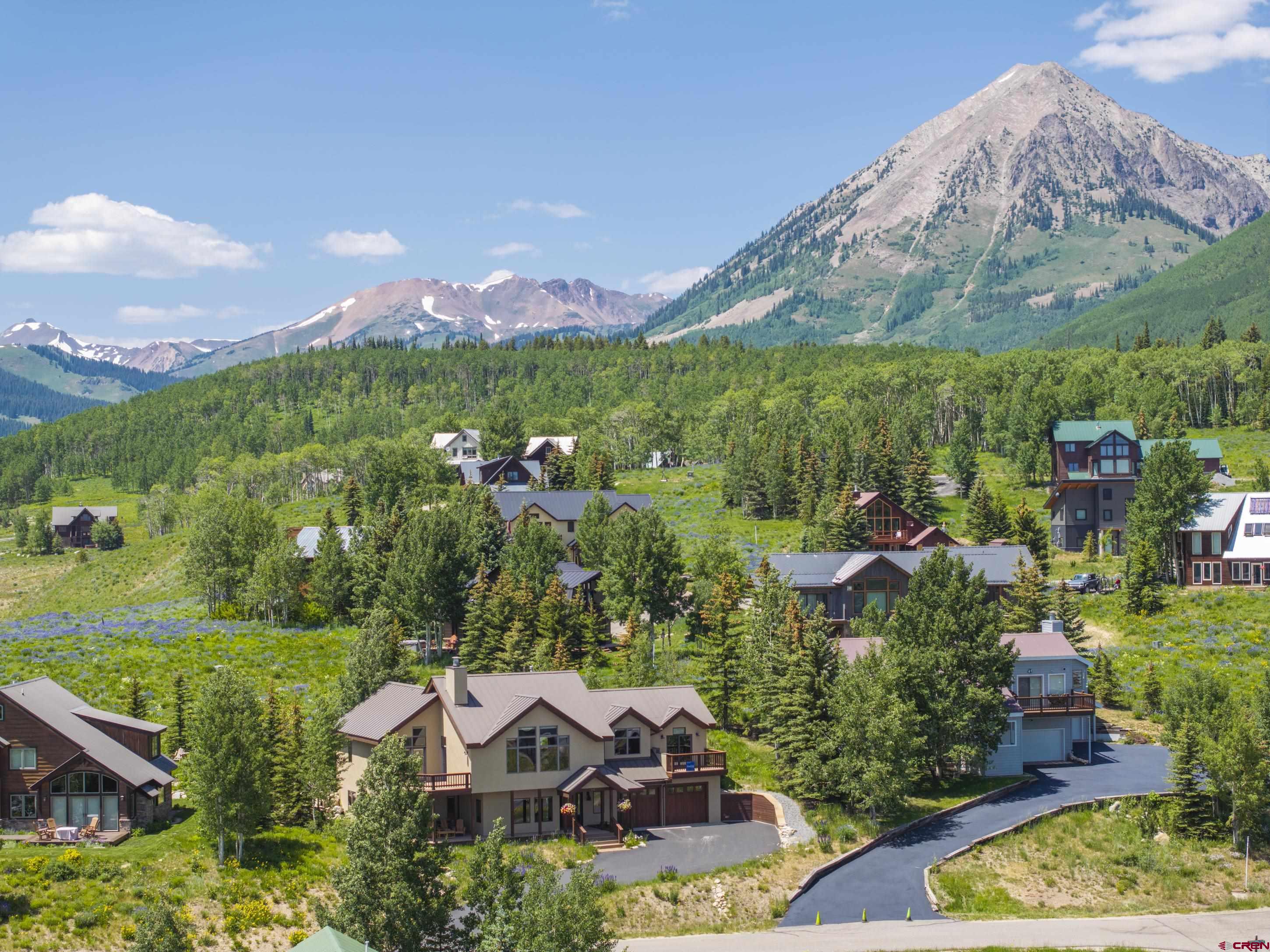 15 Nicholson Lane Crested Butte, CO 81224 - Photo 2 of 42 a view of a house with a yard and a large pool
