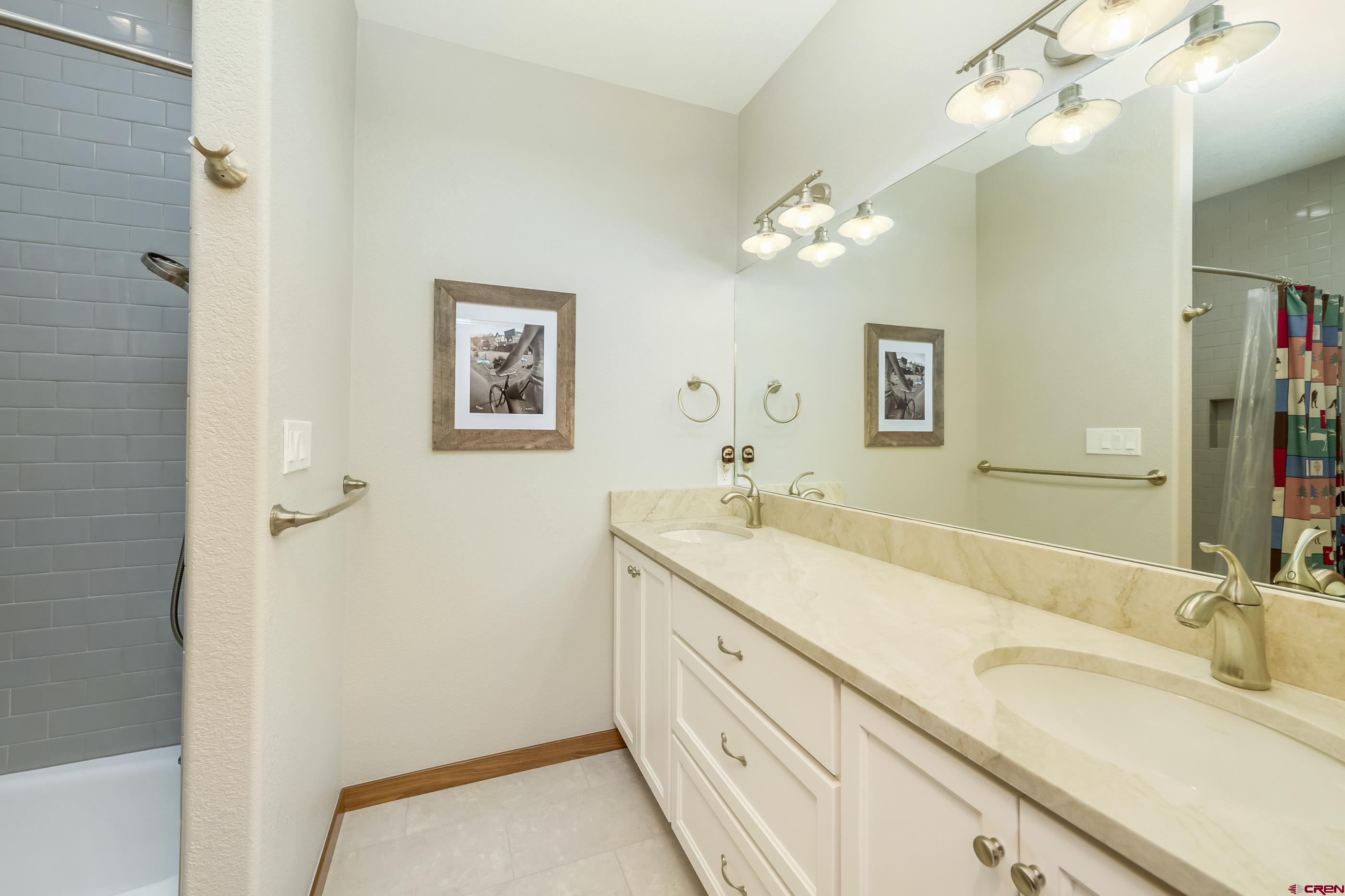 15 Nicholson Lane Crested Butte, CO 81224 - Photo 23 of 42 a spacious bathroom with a double vanity sink and a mirror
