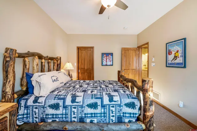 a bedroom with bed and wooden floor