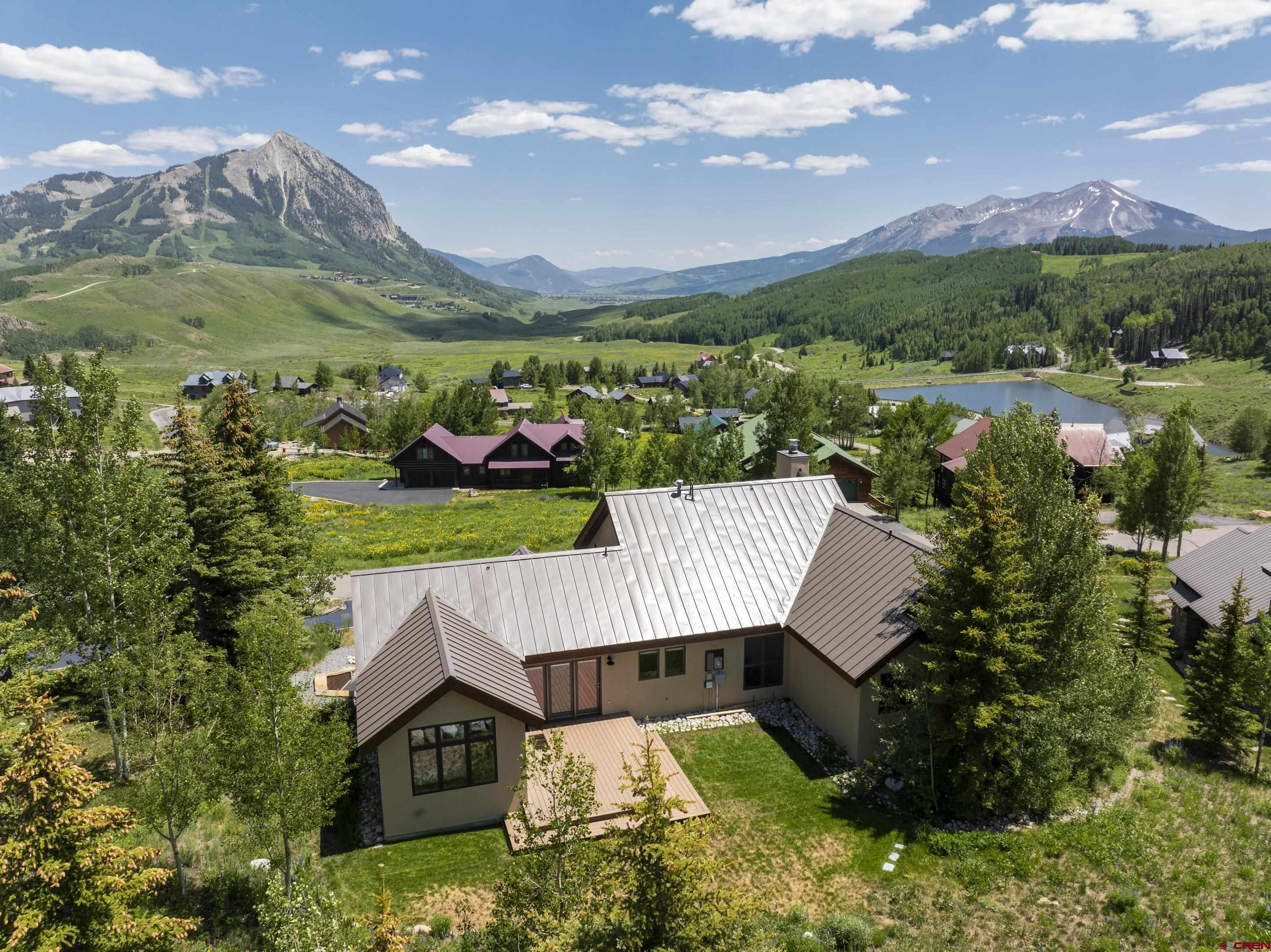 15 Nicholson Lane Crested Butte, CO 81224 - Photo 3 of 42 an aerial view of a house with a garden and lake view