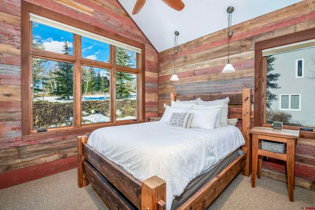 a bed sitting in a bedroom next to a window