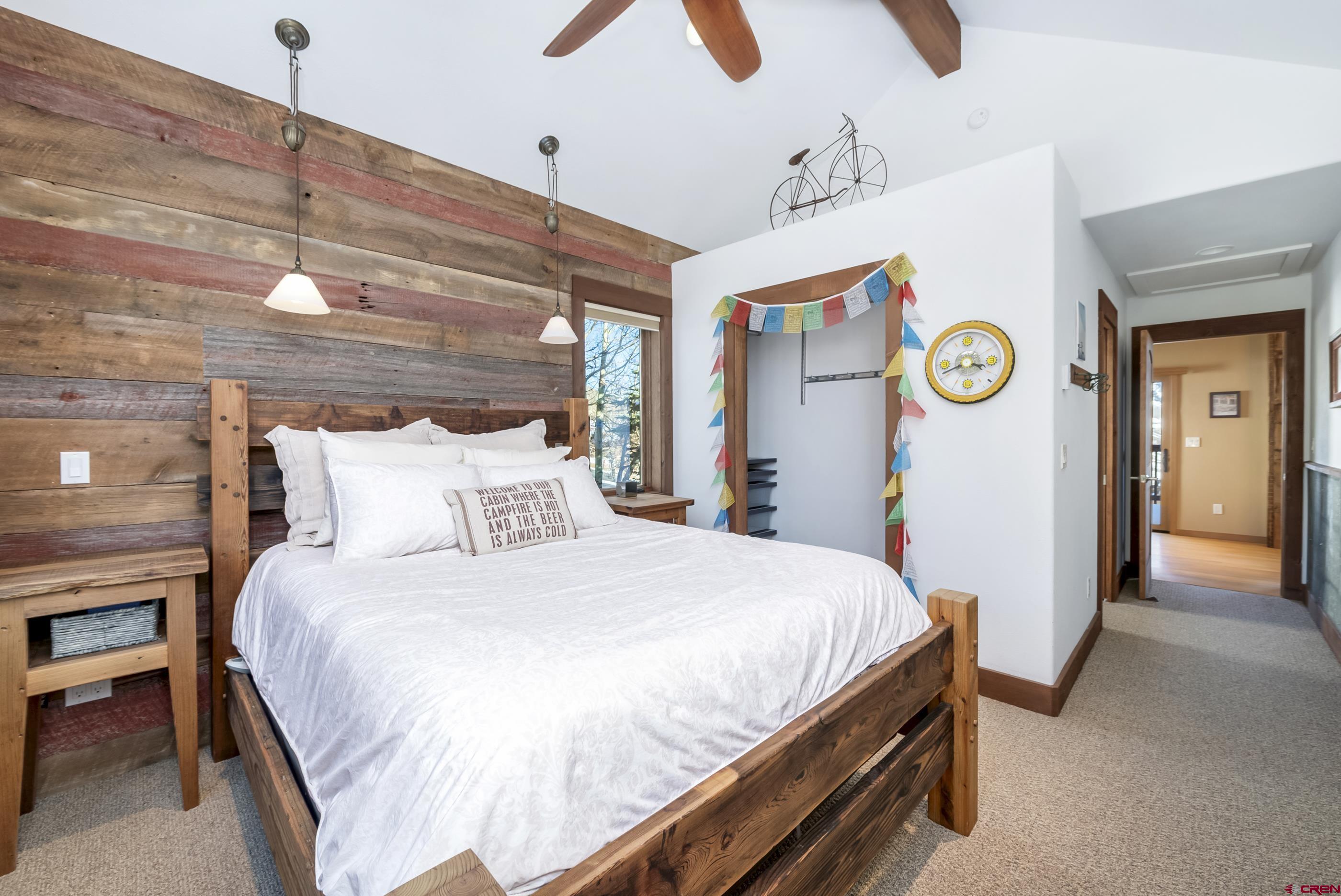 15 Nicholson Lane Crested Butte, CO 81224 - Photo 34 of 42 a bedroom with a bed and a chandelier