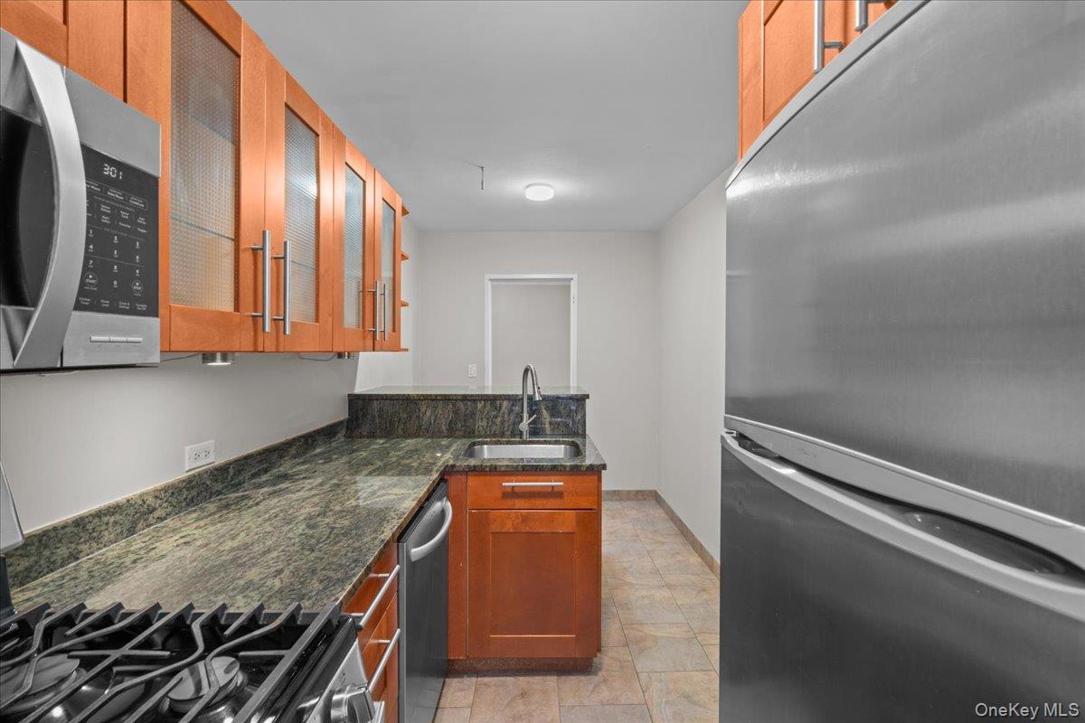 3260 Netherland Avenue, Unit 5A Bronx, NY 10463 - Photo 5 of 9 a kitchen with granite countertop cabinets and window