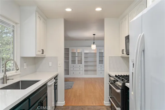 a kitchen with stainless steel appliances granite countertop a refrigerator and a sink