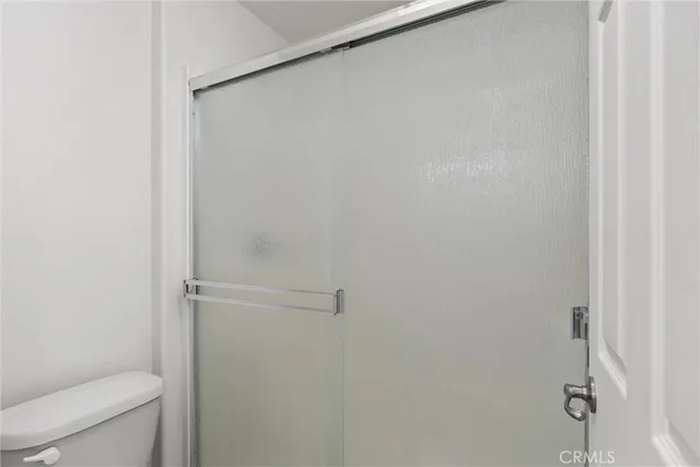 a bathroom with a shower and a toilet