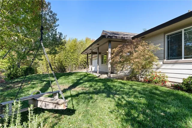 a view of house with backyard and garden